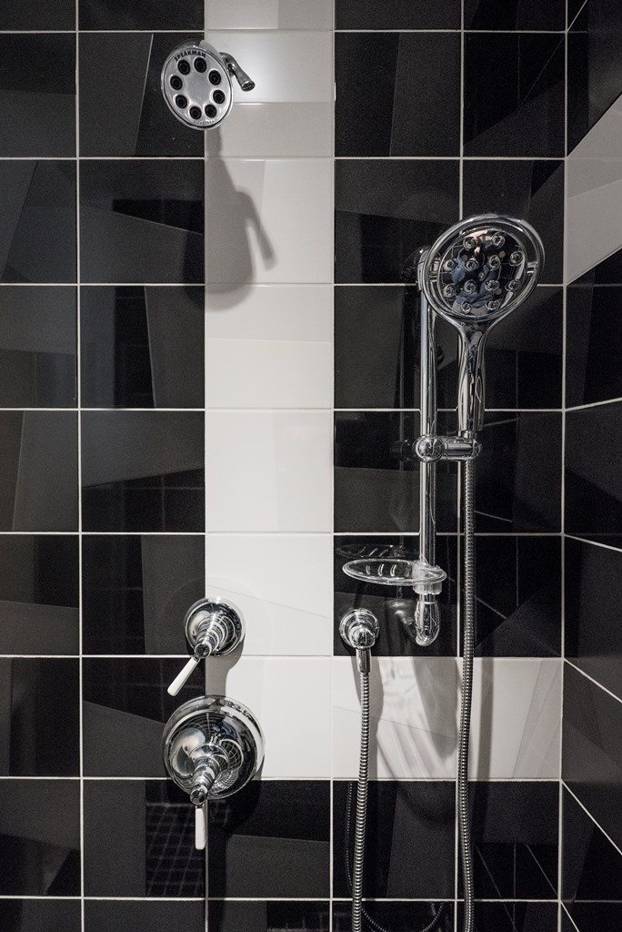 black and white bathroom with metal shower system