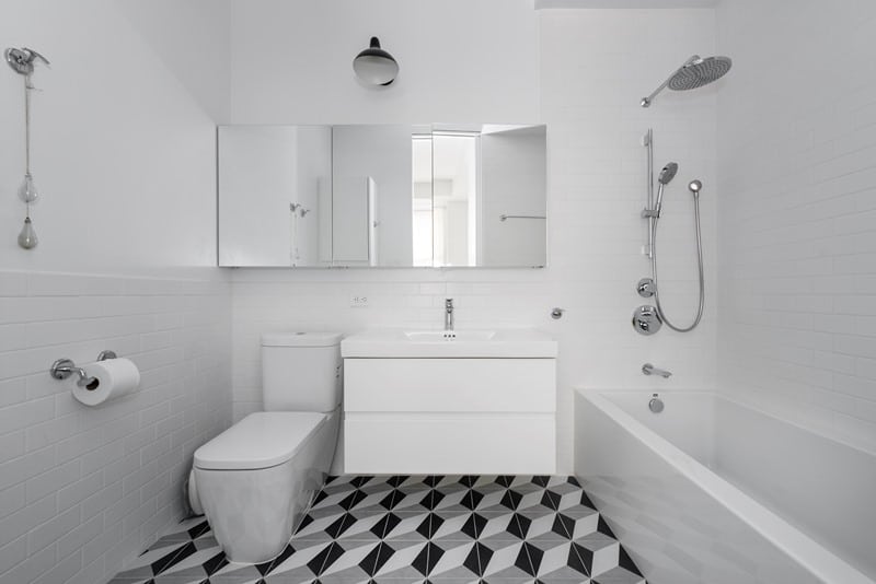 white bathroom with white and black flooring