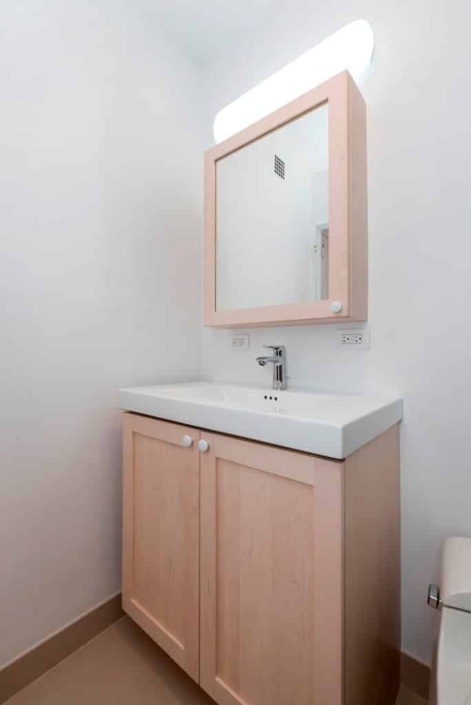 white bathroom with nude cabinets