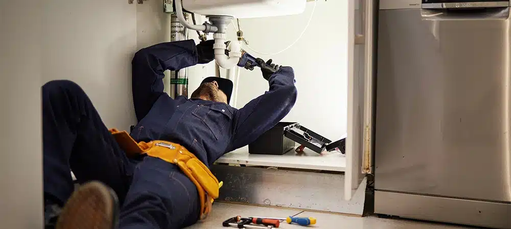 plumber repairing sink pipe