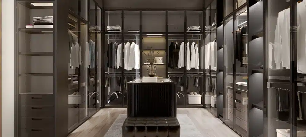 Modern black wardrobe and lighting with clothes hanging on rail in walk in closet design interior