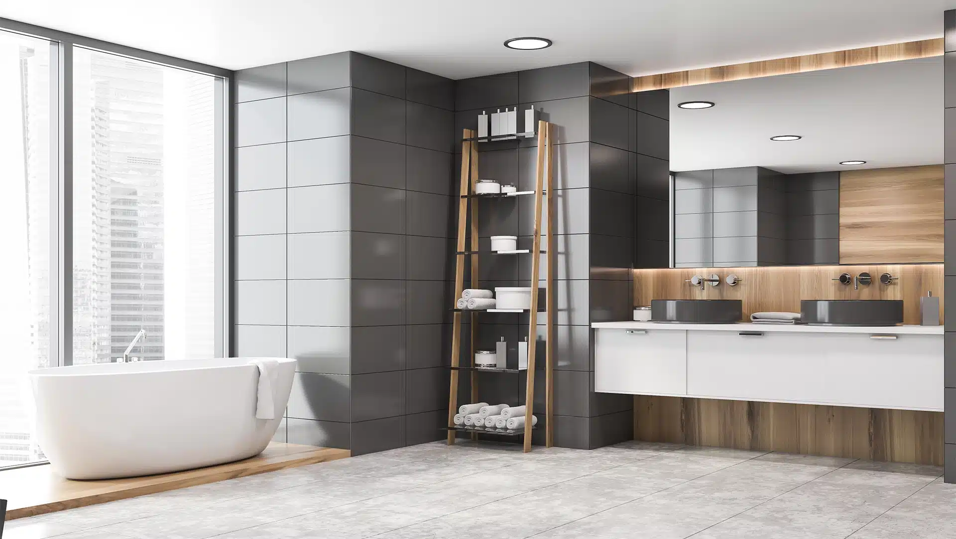 Corner of modern bathroom with gray tile and wooden walls, double sink on white countertop and comfortable bathtub. Shelves with towels and creams.