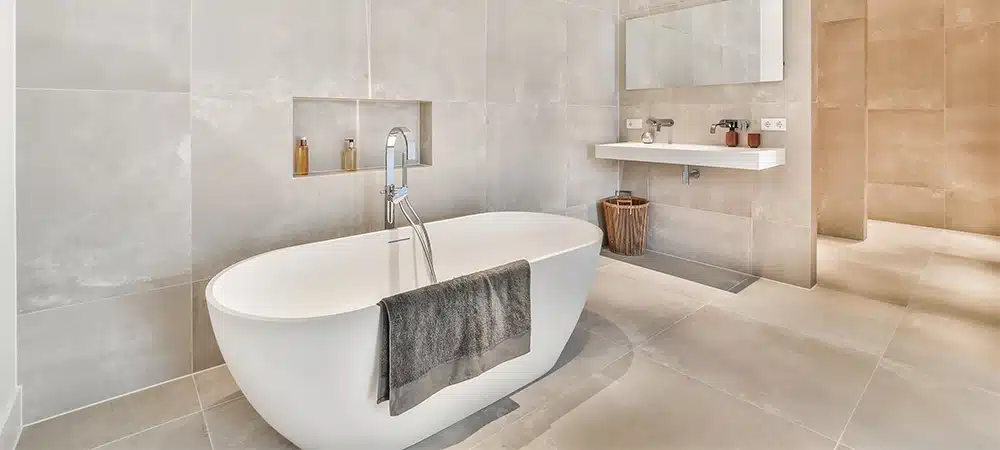 Beautiful bathroom with a big bathtub and white big windows