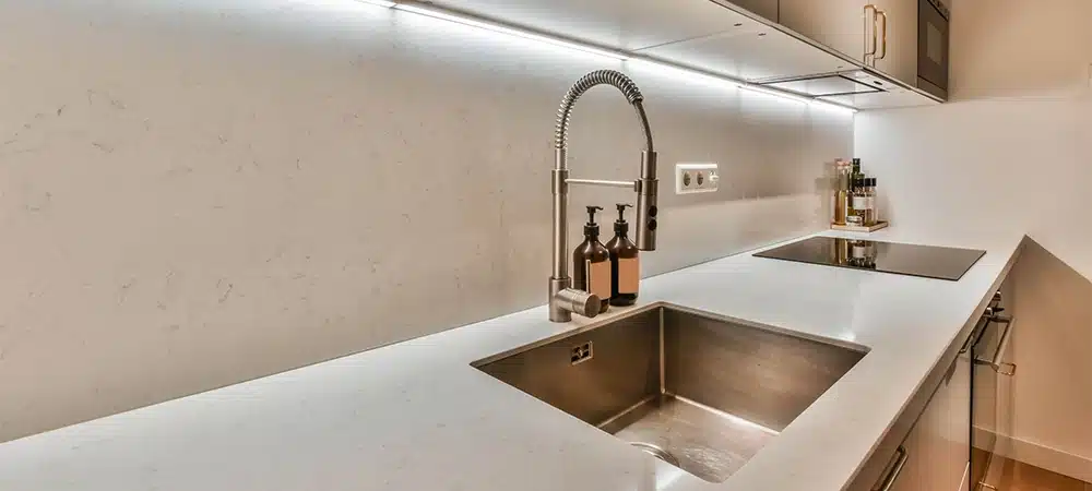 The interior of the corner kitchen of a modern house with lots of cabinets