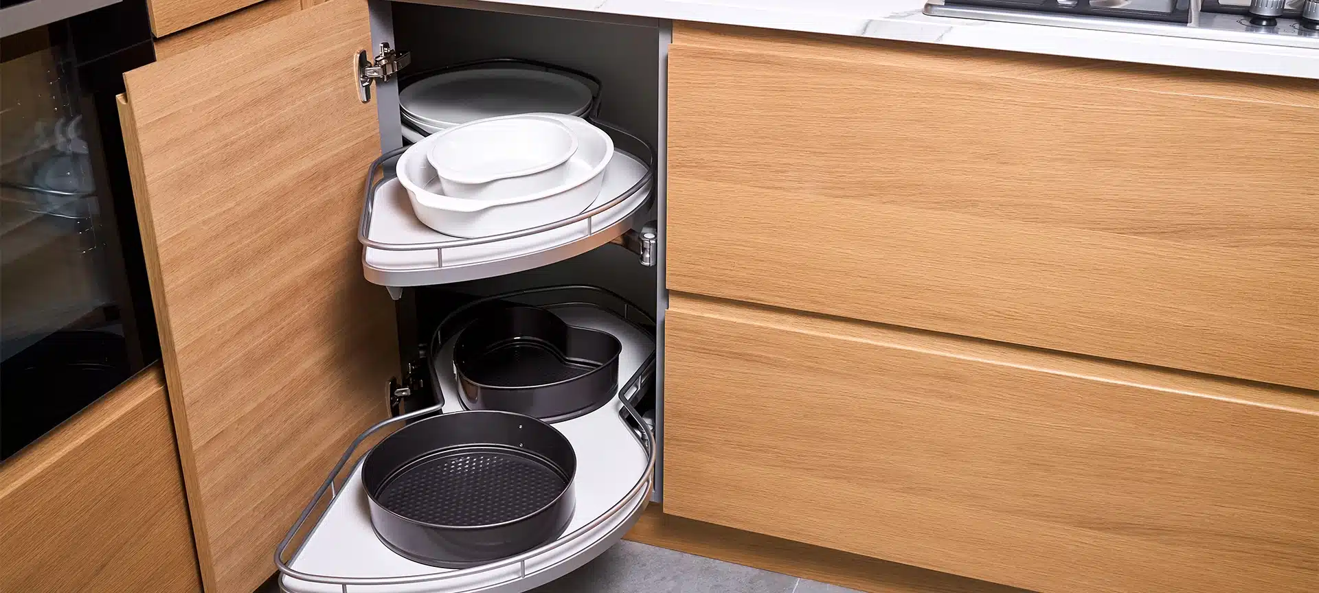 Kitchen access mechanism Magic corner for Blind Corner Cabinets. Solution for a kitchen corner storage in cupboard. Corner unit with pull out shelves for cookware.