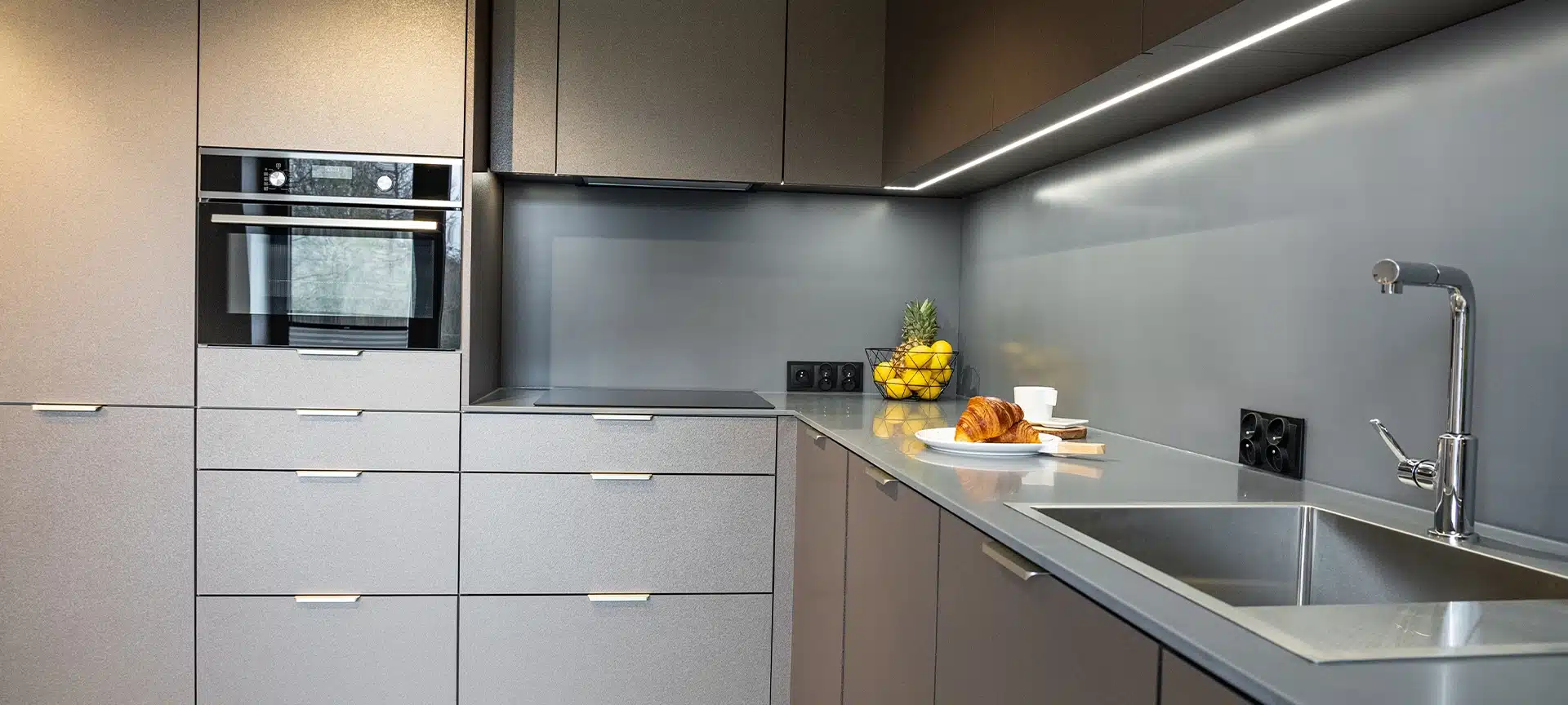 Modern furnished kitchen with household appliances and a dining room. Interior of a Modern Kitchen in a New House. Dining Table and Chairs in Stylish and Functional Space. Detailed kitchen Design.