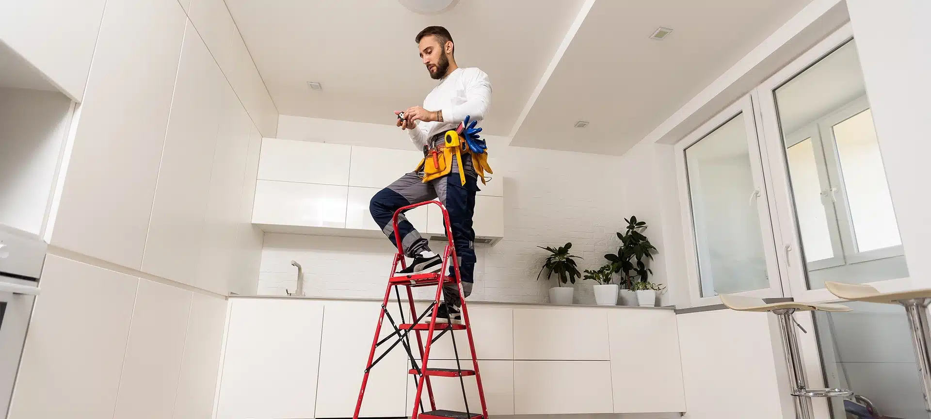 Electrician worker installation electric lamps light inside apartment. Construction decoration concept.