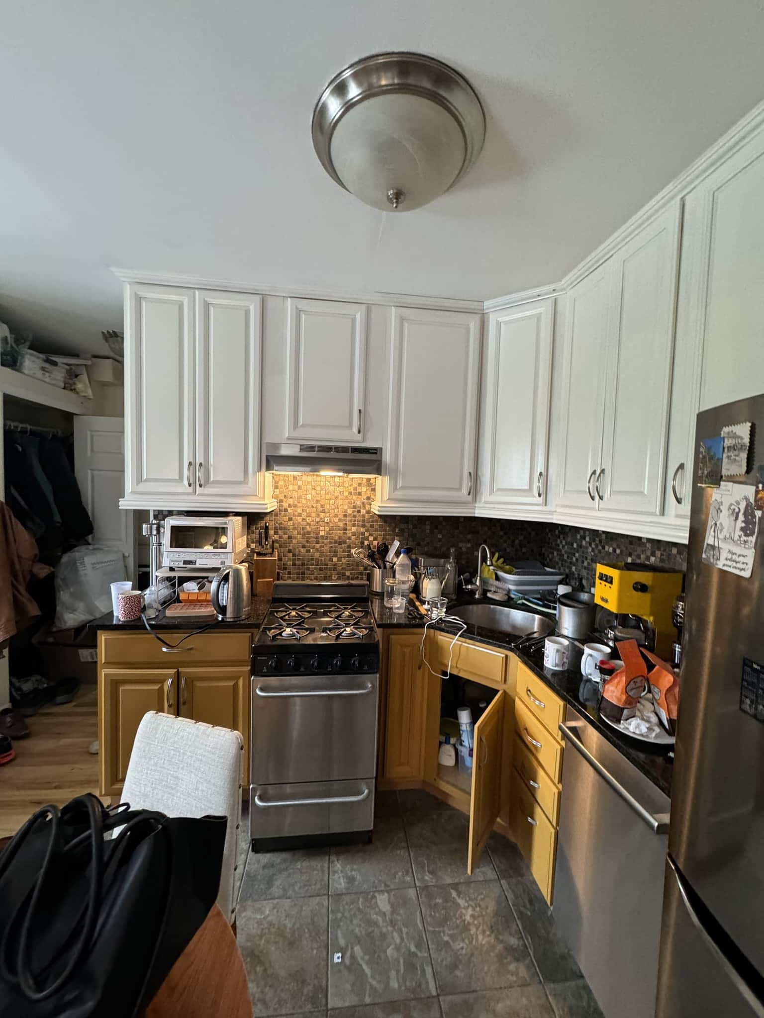 The original kitchen from the entrance, showing the range, the refrigerator and the corner cabinets