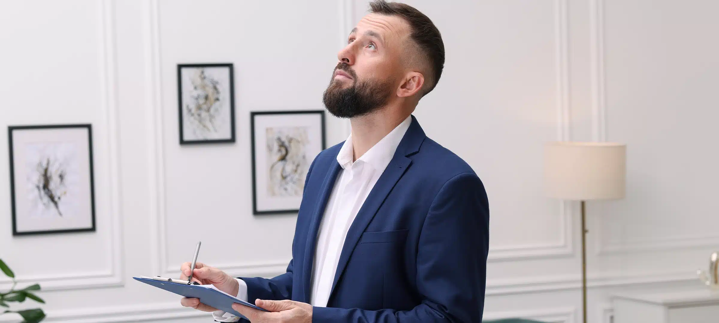 Inspector with clipboard conducting property valuation indoors