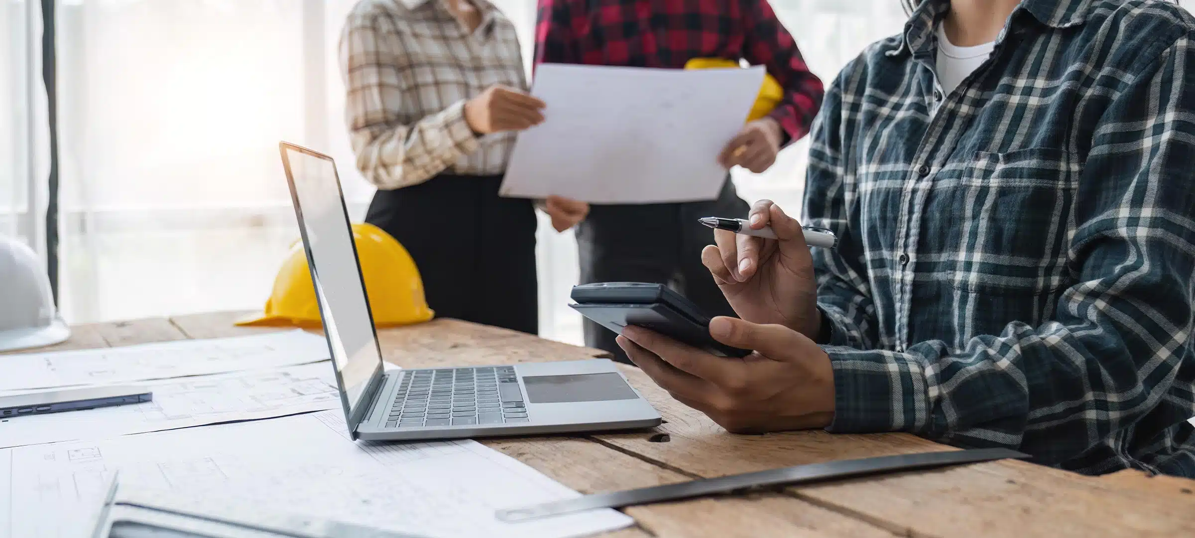 engineer working in office, engineer and architect use calculator for calculate drawing design construction, engineer discussion and estimate the cost of project