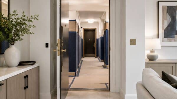 Finished Manhattan apartment entrance with professionally protected building common areas during renovation.