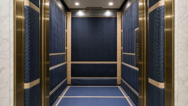Protected apartment building freight elevator prepared for renovation material deliveries.
