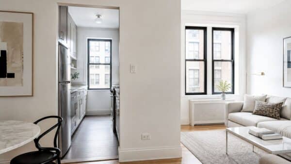 Closed NYC galley kitchen separated from the living area by an interior wall before renovation.