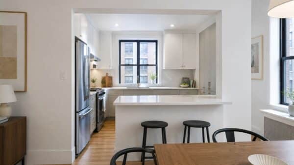 NYC kitchen connected to the living area with a wide pass-through instead of full wall removal.