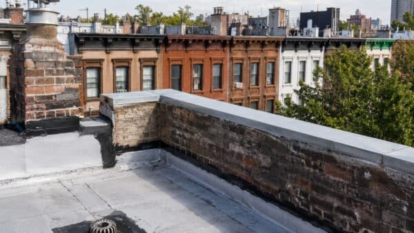NYC brownstone roof, parapet, flashing and drainage conditions evaluated before interior renovation.