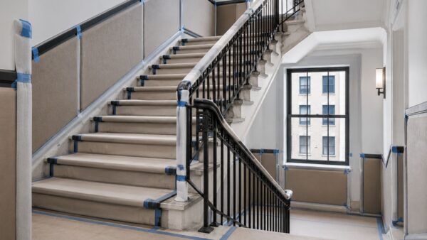 Protected Manhattan co-op staircase prepared to prevent common-area damage during apartment renovation.
