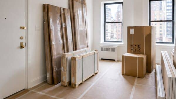 Renovation materials staged safely inside an NYC apartment after a coordinated building delivery.