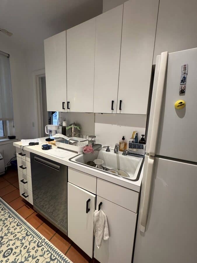 Before renovation: the original kitchen looking the other way, with the original fridge, sink and dishwasher