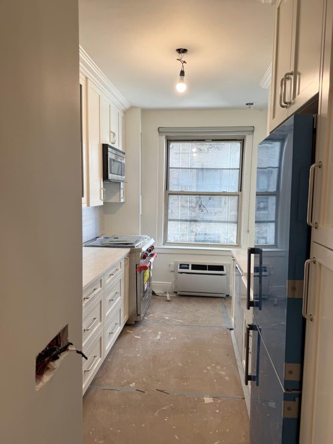 During the work at 1192 Park Avenue: Cabinets set, counters not yet in, the subfloor still bare.