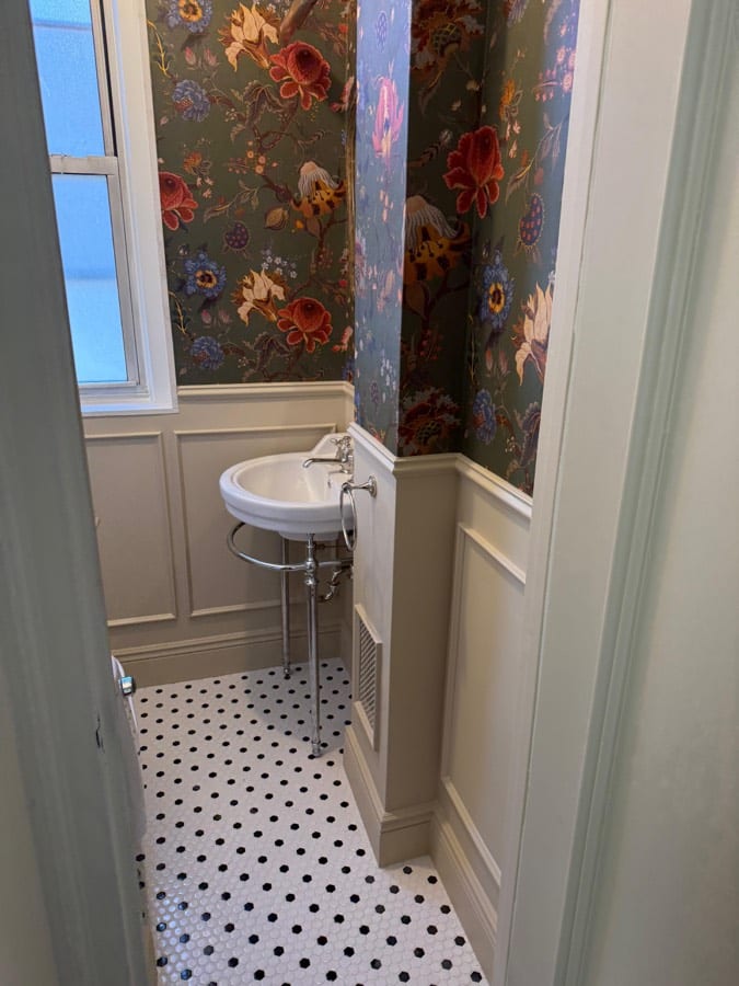During the work at 1192 Park Avenue: The powder room with the paper hung and the mosaic floor laid.