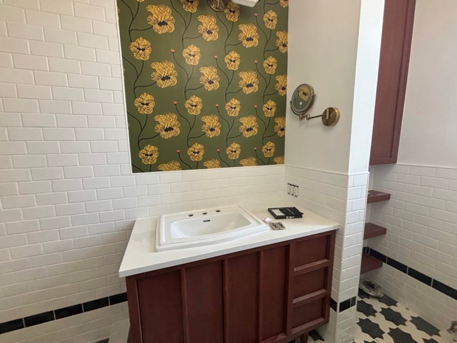 During the work at West End Avenue: The vanity set with its top, the papered panel hung. The mirror went up after this.